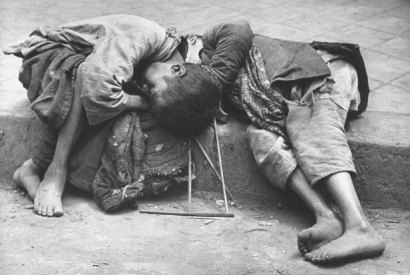 Two small children dying together in the gutter in the Chinese famine of 1946