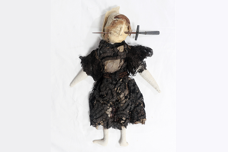 Stuffed doll in Edwardian-style black dress with stiletto through face, south Devon, England , 1909–13