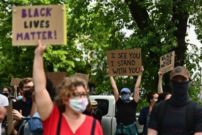 Protesters hold up signs on June 3, 2020